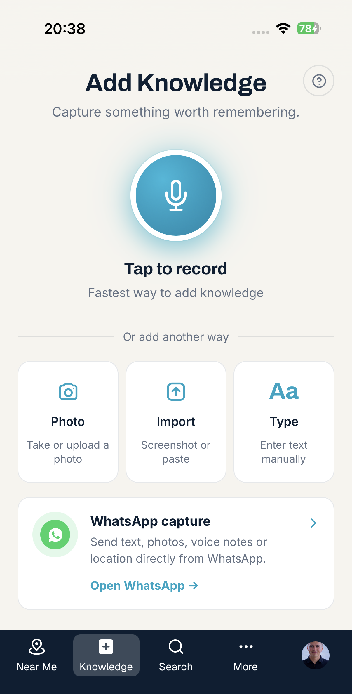 Add Knowledge screen with a large microphone button labelled Tap to record, alternative options to add a photo, import a screenshot, type manually, or capture via WhatsApp, and the site's own bottom navigation